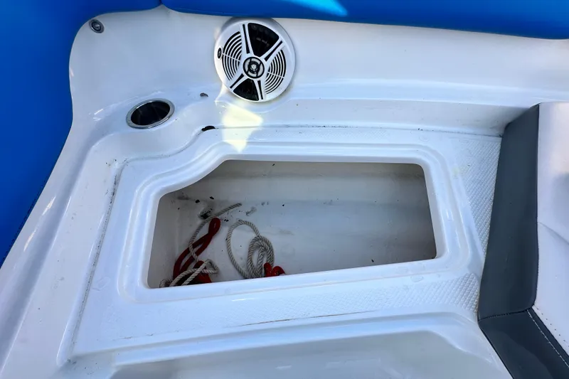 Slide: The Image of 2017 Chaparral Vortex 203 VRX boat storage compartment with speaker and ropes. - 79