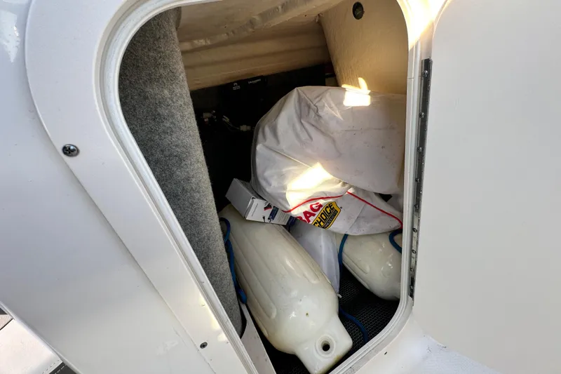 Slide: The Image of Storage compartment of 2017 Chaparral Vortex 203 VRX boat with fenders and gear. - 72