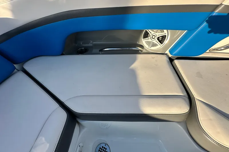 Slide: The Image of 2017 Chaparral Vortex 203 VRX boat interior with blue and white seating, speaker, and cup holder. - 56