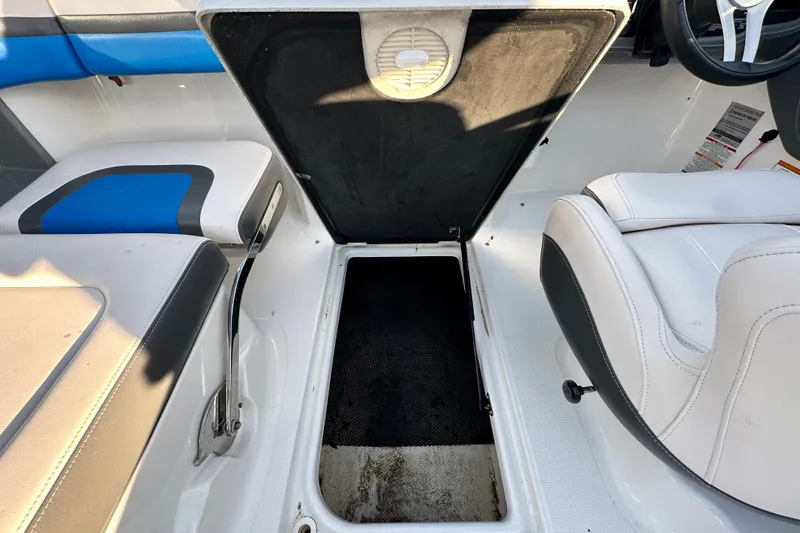 Slide: The Image of 2017 Chaparral Vortex 203 VRX interior with open storage compartment and seating. - 68