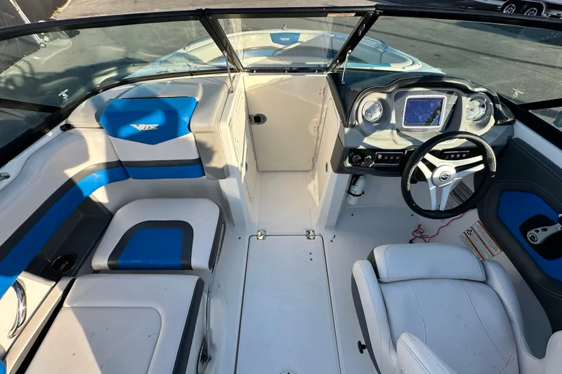 Slide: The Image of 2017 Chaparral Vortex 203 VRX boat interior with blue and white seating, modern dashboard. - 16