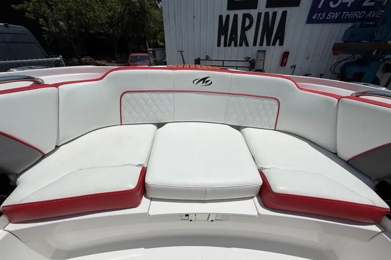 Slide: The Image of White and red seating on a 2017 Monterey M-65 boat, docked at a marina. - 87