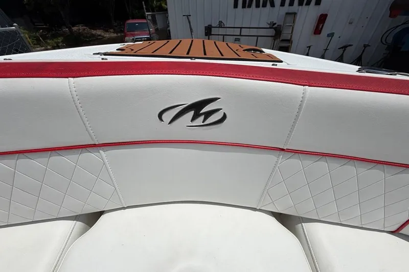 Slide: The Image of White and red interior of a 2017 Monterey M-65 boat with logo detail. - 93