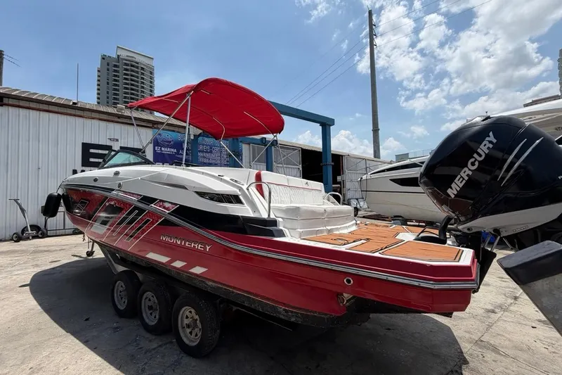 Slide: The Image of 2017 Monterey M-65 boat with red canopy and Mercury engine at marina. - 14