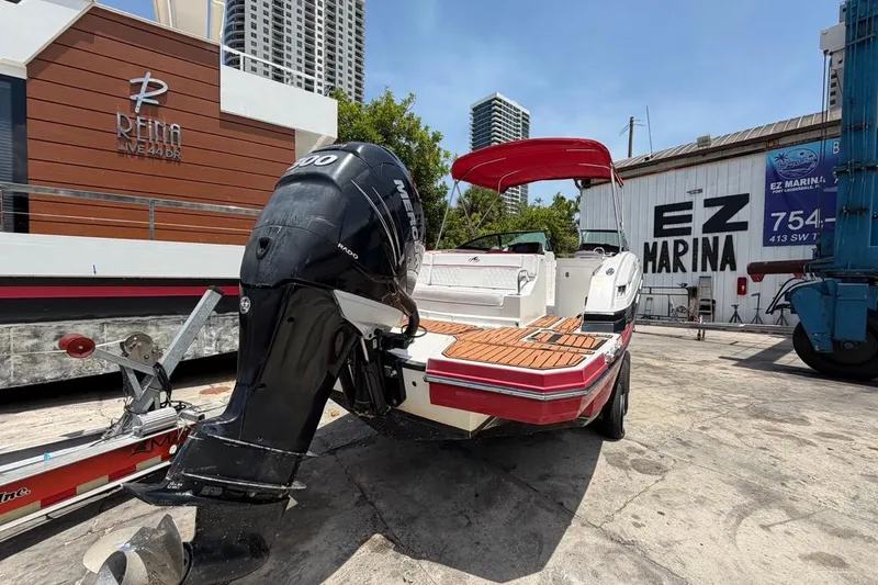 Slide: The Image of 2017 Monterey M-65 boat with Mercury engine at EZ Marina, featuring red canopy and wooden deck. - 9