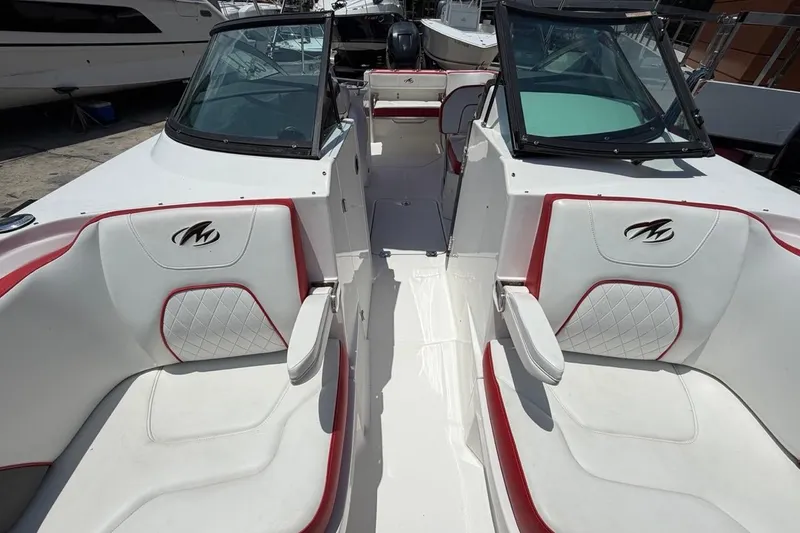 Slide: The Image of 2017 Monterey M-65 boat interior with white and red seating, docked at marina. - 94