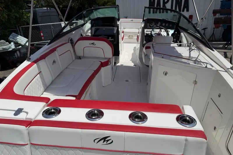 Slide: The Image of 2017 Monterey M-65 boat interior with red and white seating, sleek design, and modern dashboard. - 116
