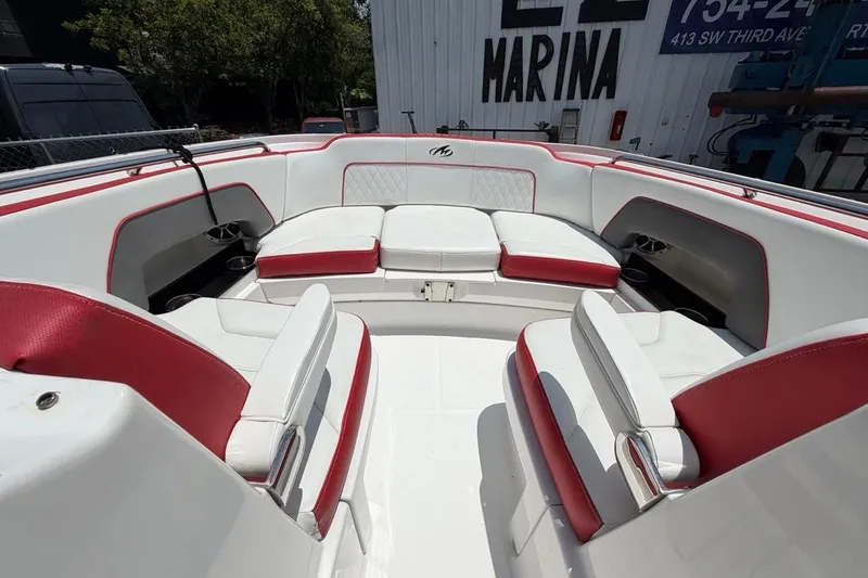 Slide: The Image of 2017 Monterey M-65 boat interior with red and white seating, docked at marina. - 84