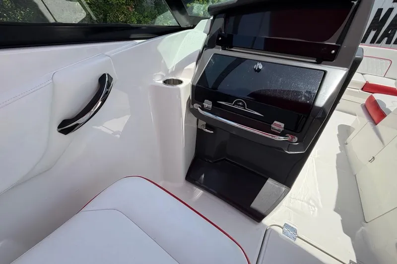 Slide: The Image of Interior of a 2017 Monterey M-65 boat, featuring sleek white seating and modern dashboard. - 65
