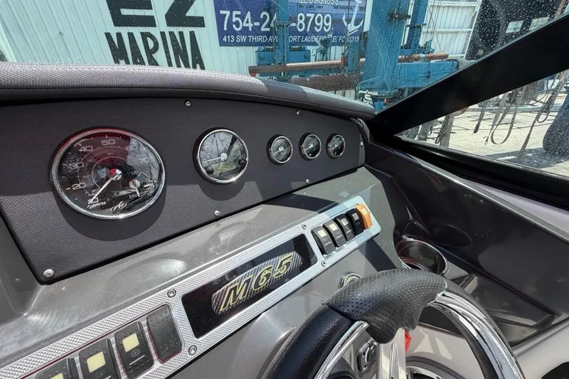 Slide: The Image of Dashboard of a 2017 Monterey M-65 boat with gauges and controls. - 68