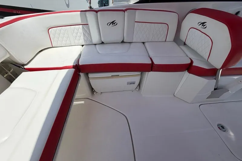 Slide: The Image of Luxurious seating on a 2017 Monterey M-65 boat, featuring white and red upholstery. - 55
