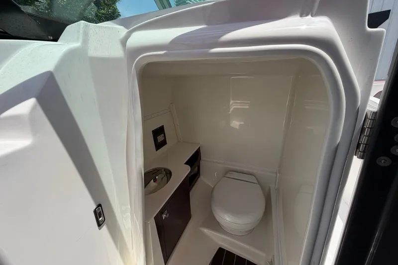 Slide: The Image of Compact bathroom in 2017 Monterey M-65 boat with toilet and sink. - 74