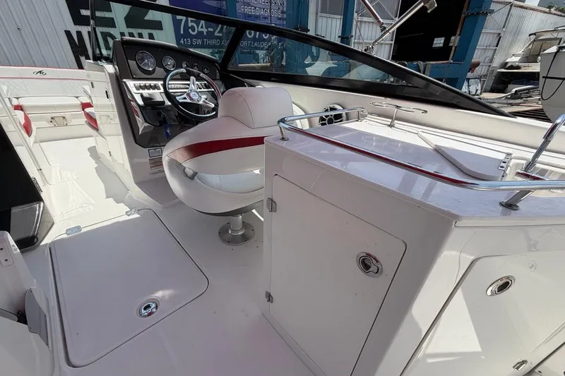 Slide: The Image of 2017 Monterey M-65 boat interior with steering wheel, seating, and control panel. - 58