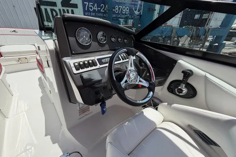 Slide: The Image of Cockpit of a 2017 Monterey M-65 boat with steering wheel and control panel. - 66