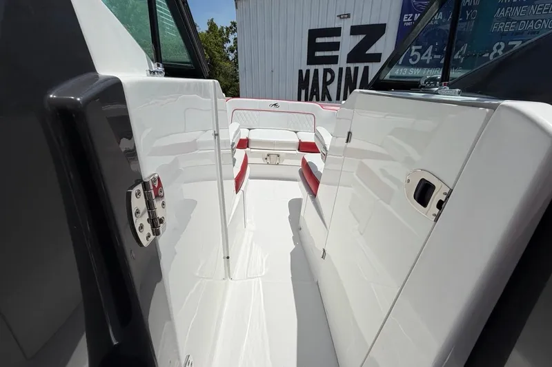 Slide: The Image of 2017 Monterey M-65 boat interior with white and red seating, docked at EZ Marina. - 81