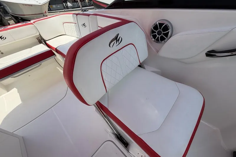 Slide: The Image of 2017 Monterey M-65 boat interior with white and red seating, featuring stylish design and speaker. - 100