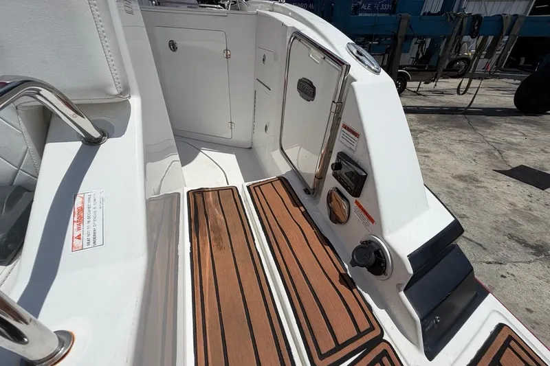 Slide: The Image of 2017 Monterey M-65 boat deck with teak flooring and stainless steel fixtures. - 51