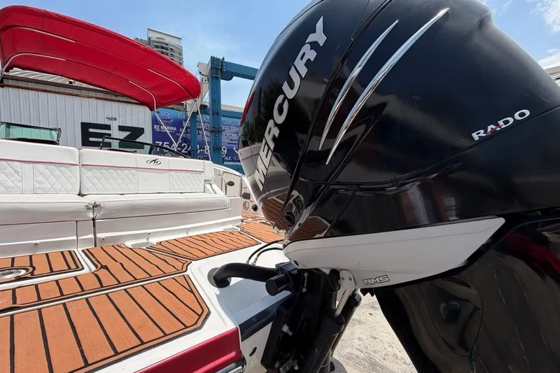 Slide: The Image of 2017 Monterey M-65 boat with Mercury outboard engine, featuring teak flooring and red canopy. - 35