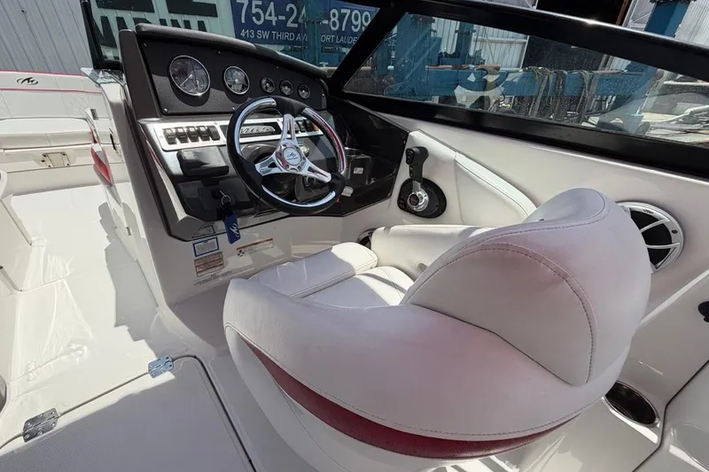 Slide: The Image of Interior of a 2017 Monterey M-65 boat showing steering wheel and dashboard controls. - 63