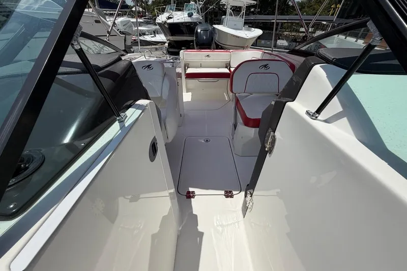 Slide: The Image of Interior view of a 2017 Monterey M-65 boat with white and red seating. - 96