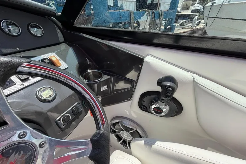Slide: The Image of Cockpit of a 2017 Monterey M-65 boat with steering wheel and controls. - 69