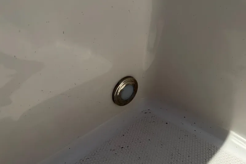 Slide: The Image of Close-up of a 2017 Monterey M-65 boat drain plug in a white interior. - 107