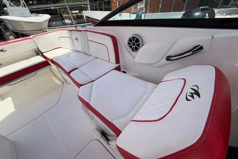 Slide: The Image of Interior of a 2017 Monterey M-65 boat with red and white seating. - 101