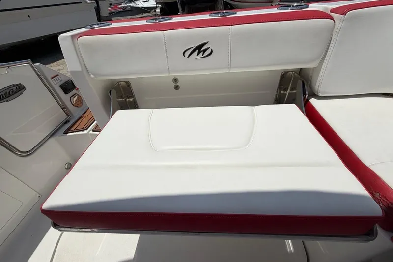 Slide: The Image of White and red seating on a 2017 Monterey M-65 boat, featuring logo detail. - 103