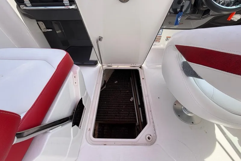 Slide: The Image of Open hatch on 2017 Monterey M-65 boat interior with red and white seating. - 99