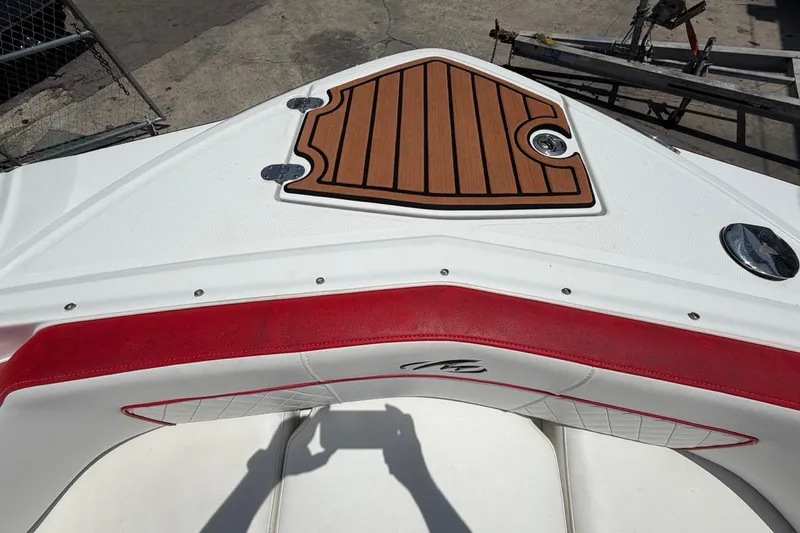 Slide: The Image of Bow of 2017 Monterey M-65 boat with teak deck and red trim. - 90
