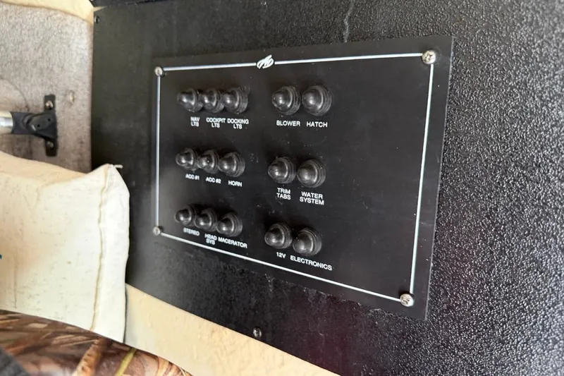 Slide: The Image of Control panel of a 2017 Monterey M-65 boat with labeled switches. - 112
