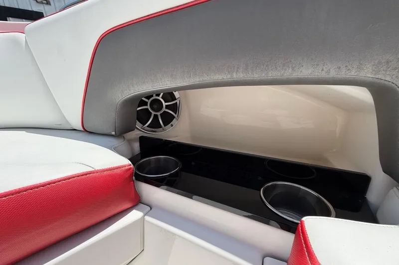 Slide: The Image of Interior of 2017 Monterey M-65 boat with red and white seating, cup holders, and speaker. - 88