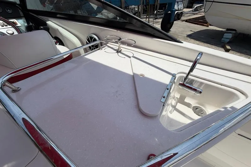 Slide: The Image of 2017 Monterey M-65 boat interior with sink and countertop, featuring chrome fixtures and white seating. - 59