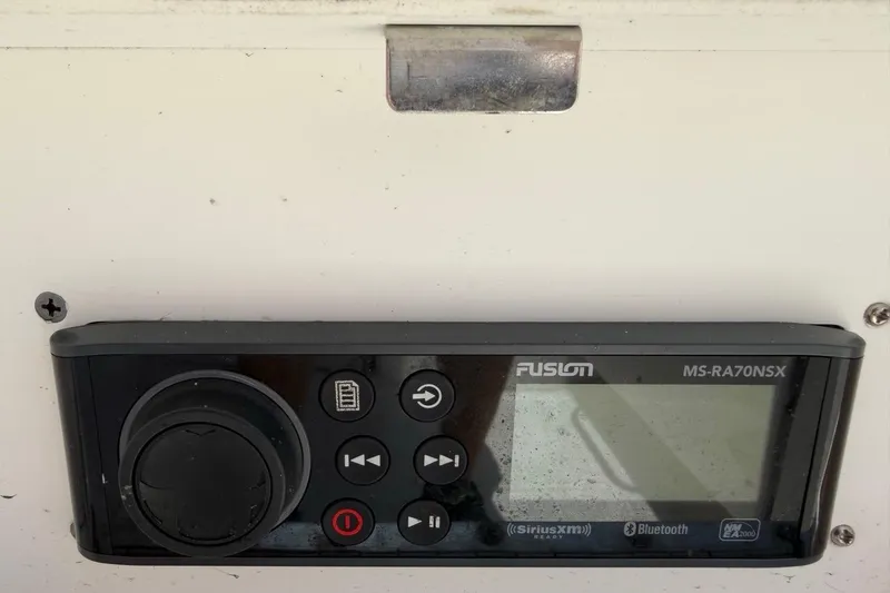 Slide: The Image of Fusion MS-RA70NSX marine stereo on a 2017 Monterey M-65 boat dashboard. - 105