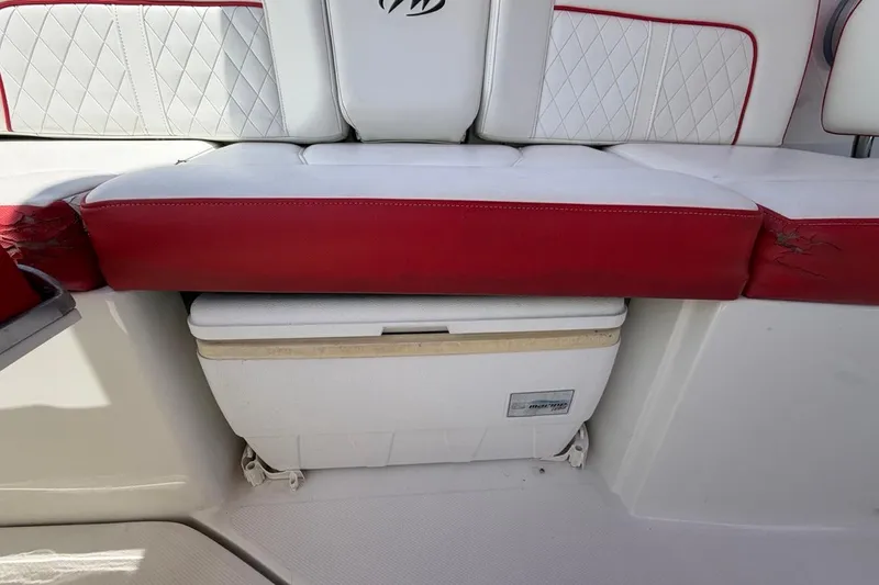 Slide: The Image of Red and white seating on a 2017 Monterey M-65 boat with storage compartment. - 56
