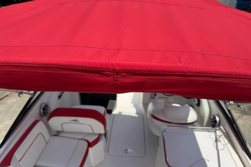 Slide: The Image of Red canopy on 2017 Monterey M-65 boat with white and red seating. - 118