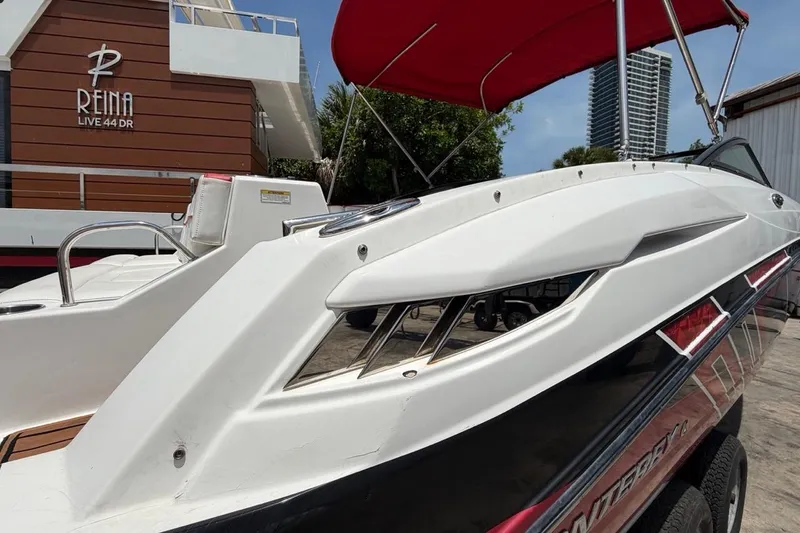 Slide: The Image of 2017 Monterey M-65 boat with red canopy, docked near Reina building. - 42
