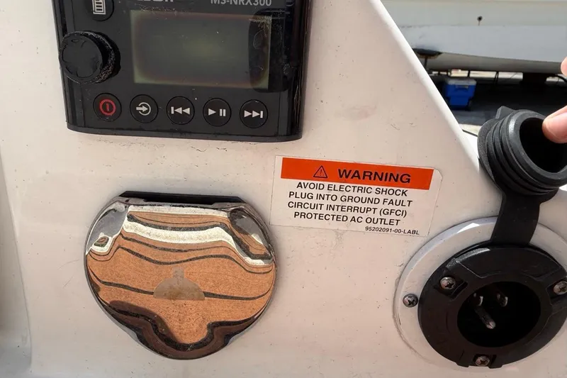 Slide: The Image of Control panel of a 2017 Monterey M-65 with warning label and GFCI outlet. - 119