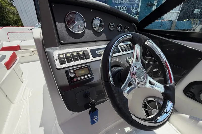 Slide: The Image of Steering console of a 2017 Monterey M-65 boat with gauges and controls. - 67