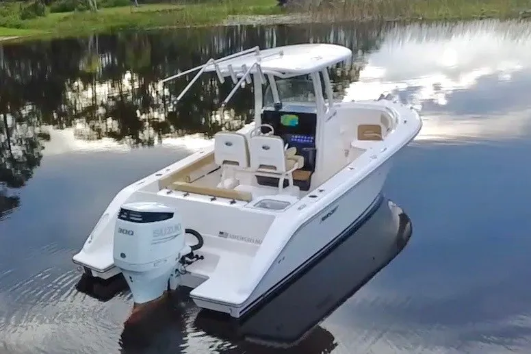 Slide: The Image of 2017 Pursuit C 238 Center Console boat on calm water. - 24