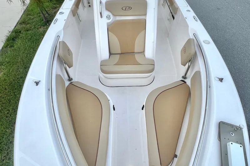 Slide: The Image of 2017 Pursuit C 238 Center Console boat interior with tan seating and white deck. - 78