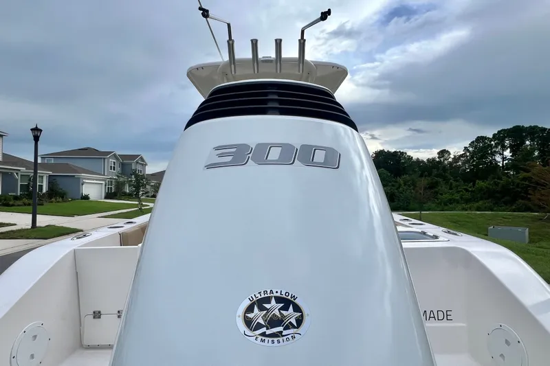 Slide: The Image of 2017 Pursuit C 238 Center Console boat with 300 horsepower engine, parked in a residential area. - 10