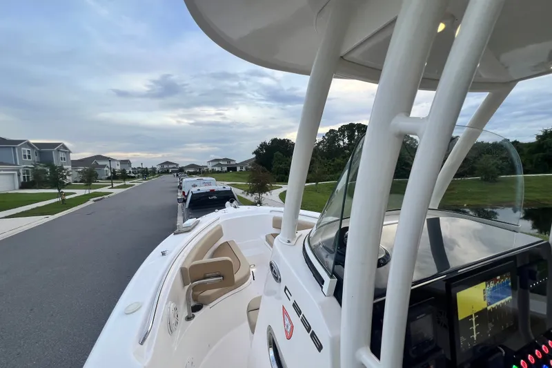Slide: The Image of 2017 Pursuit C 238 Center Console boat parked on a suburban street. - 57