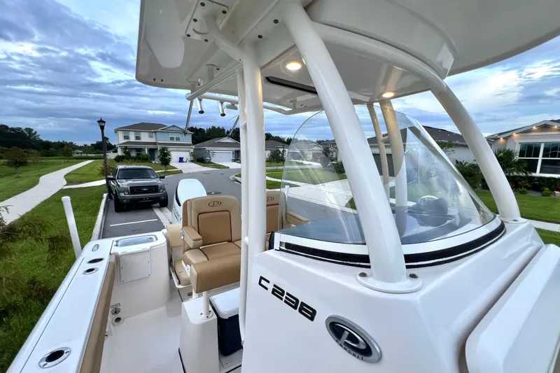 Slide: The Image of 2017 Pursuit C 238 Center Console boat parked in a residential neighborhood. - 87