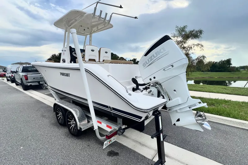 Slide: The Image of 2017 Pursuit C 238 Center Console boat on trailer with Suzuki outboard motor. - 14