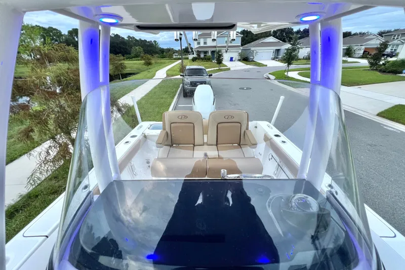 Slide: The Image of 2017 Pursuit C 238 Center Console boat parked in a suburban neighborhood. - 39