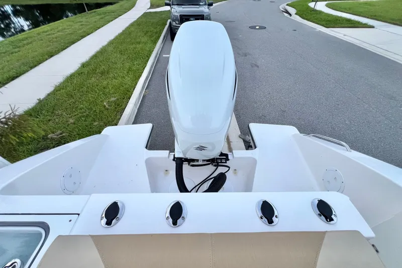 Slide: The Image of 2017 Pursuit C 238 Center Console boat with outboard motor on a street. - 27
