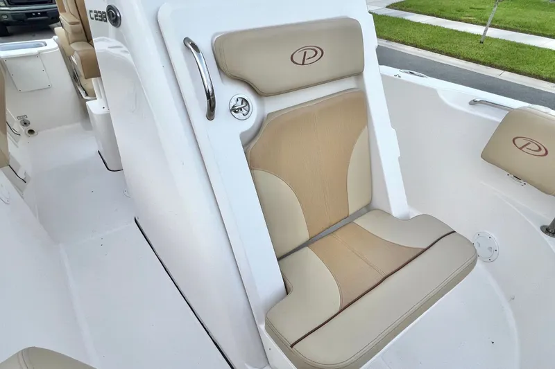 Slide: The Image of 2017 Pursuit C 238 Center Console boat interior with beige seating. - 85