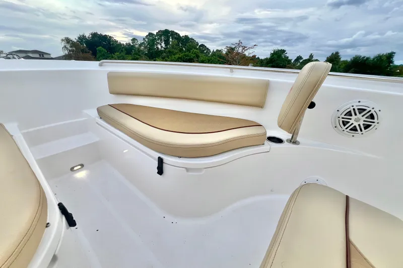 Slide: The Image of 2017 Pursuit C 238 Center Console boat interior with beige seating and speaker. - 63