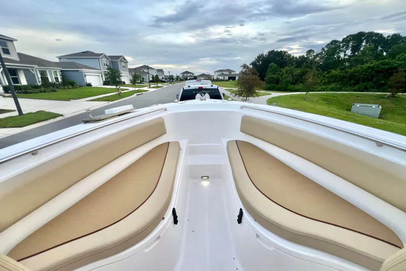 Slide: The Image of 2017 Pursuit C 238 Center Console boat on suburban street, showcasing bow seating. - 68